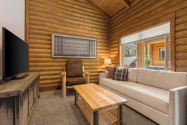 Enjoy the warm ambiance of log walls, handcrafted furniture, and large windows that frame the serene mountain surroundings.