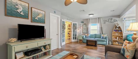Bright living area with ample seating and Smart TV