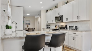 Sip morning coffee or grab a bite at the kitchen counter, with seating for 2