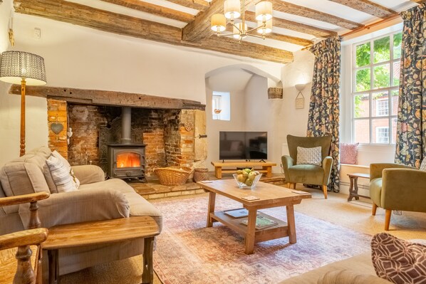 The Old Gatehouse, Walsingham: Sitting room with wood burning stove