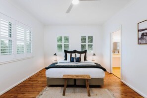 The primary bedroom is set with a comfortable king bed, ceiling fan and plantation shutters to filter light for a good nights' sleep.