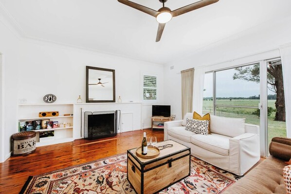 The main living area centres around a wood-burning fireplace—perfect for cosy winter evenings.