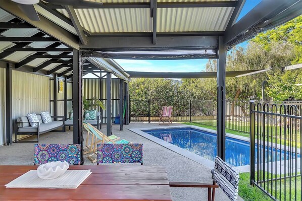 The back patio offers an undercover alfresco area overlooking the pool.