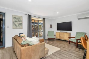 A cosy sofa and armchairs in the lounge area are perfect to settle into with a movie, while split system air-conditioning ensures year-round comfort.