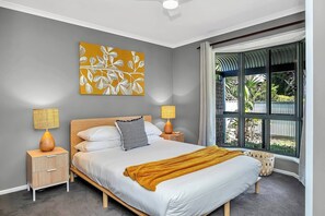 The beautifully appointed first bedroom features a queen-size with side tables and reading lamps, while all bedrooms include ceiling fans. 