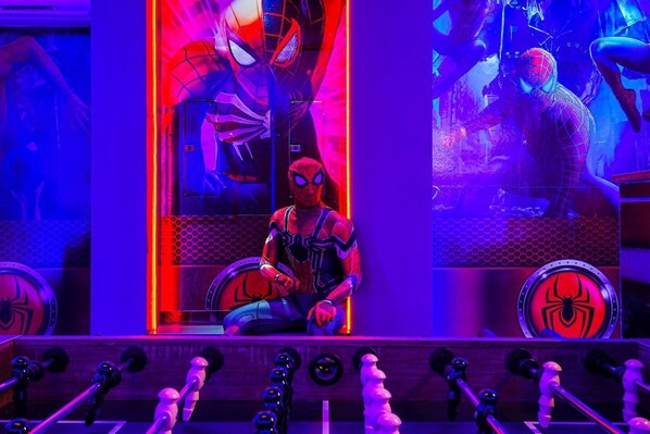 Step into an extraordinary Spider-Man-themed arcade room, where custom details and vibrant design bring superhero adventures to life