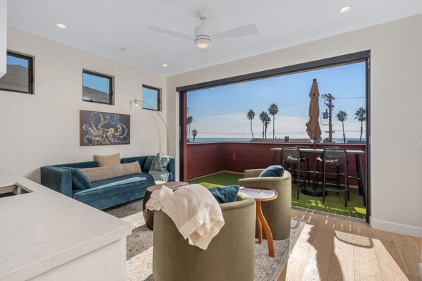 Third level seating area with patio and ocean views