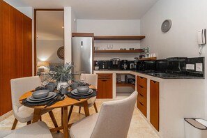 A cozy dining space perfect for meals with a view of the kitchenette