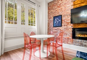 A chic dining nook with clear chairs and natural light provides the perfect spot to enjoy your meals or a cup of coffee while soaking in the downtown vibes.