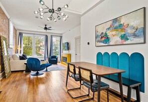 The dining area seamlessly flows into the living space, creating an open and inviting layout for enjoying meals or company.