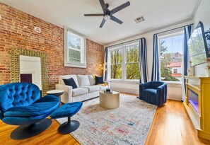 A cozy living area filled with colorful accents and natural light, perfect for unwinding after a day of adventure.
