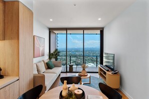 Bright living room with stunning hinterland and river views, featuring a Netflix-enabled TV for your entertainment.