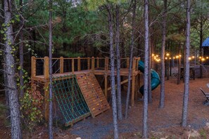 Outdoor play set with slide and rock climbing wall
