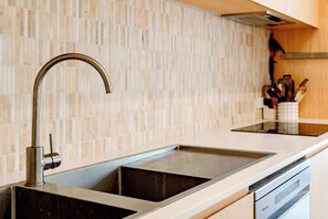 Stunning kitchen features an induction cooktop, electric oven, and walk-in pantry