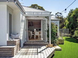 A fully enclosed garden with lush greenery, offering privacy and a peaceful nature-filled setting.
