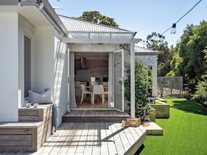 A fully enclosed garden with lush greenery, offering privacy and a peaceful nature-filled setting.