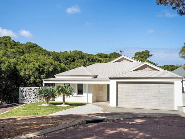 The modern façade and double garage provide both style and convenience for your stay.