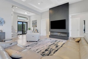 Every room of the home has a SmartTV with Xfinity cable; in the great room, the TV is mounted on the stunning fire feature wall.