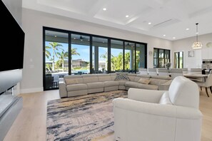 Large-scale furnishings grace the great room - the central hub of the home with living, dining and kitchen in one voluminous space.