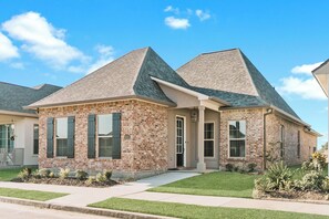 An exterior view of your next stay in an expertly maintained property, built in 2022. The home is one mile from a newly developed golf course. 