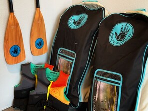 Two standup paddle boards and two youth lifejackets