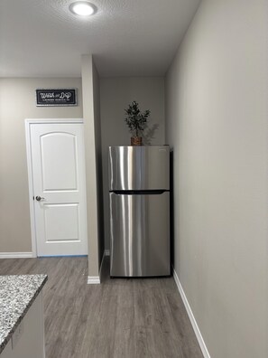 Large fridge that has Ice cube trays and a Brita water pitcher. 