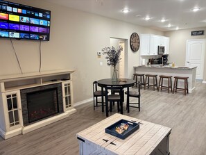Electric fireplace and Large Smart TV in living room.