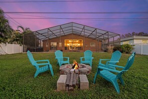 Cozy fire pit surrounded by chairs, ideal for relaxing evening.