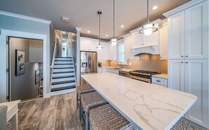 Kitchen area and kitchen island which can seat 3
