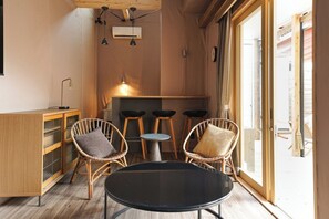 The loft overlooking the living room is the sleeping space.