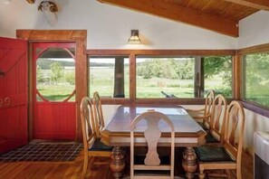 Big dining table with a view of the fields, orchards and pond
