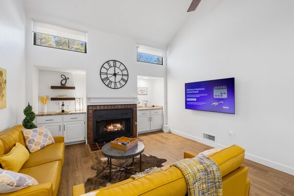 Enjoy the warmth of the fire in a stylish and inviting living room, designed for ultimate relaxation.