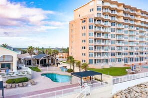 Aerial view of this enormous pool deck with multiple seating areas