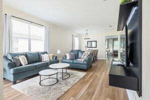 Whether you're binge-watching your favorite shows or just catching up with loved ones, this spacious living room is made for connection and comfort.