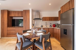 Enjoy meals and conversation at this cozy dining table, just steps from the kitchenette