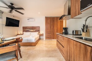 Enjoy meals and conversation at this cozy dining table, just steps from the kitchenette