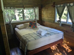 Our cabin room offers a peaceful and warm retreat. Comfortable sheet, towels, wooden clothes hanger, nice space.