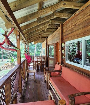 The front porch overlooks the water, offering a perfect spot to relax, enjoy the view, watch local birdlife, or spot turtles gliding through the water below.