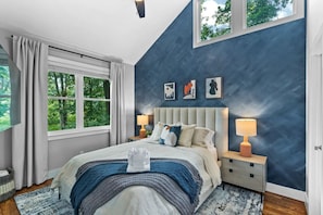 Enjoy natural light and a peaceful ambiance in our inviting blue bedroom.