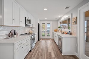 Fully stocked kitchen with deck access.