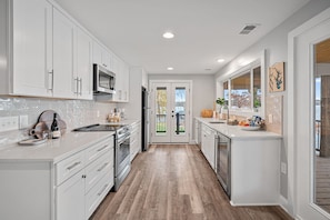 Fully stocked kitchen with deck access.