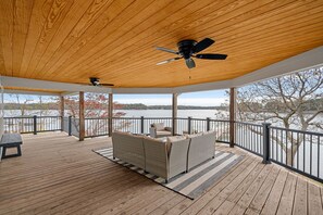Upper level deck with sectional and ceiling fan.