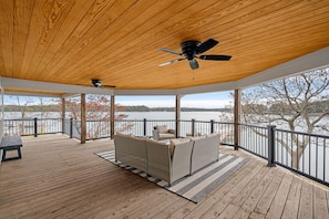 Upper level deck with sectional and ceiling fan.