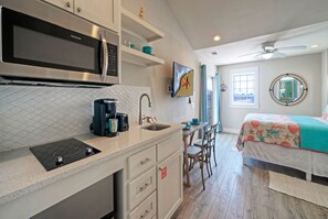 Kitchenette with a microwave and two-burner stove.