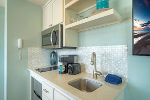 Kitchenette with a microwave and two-burner stove.