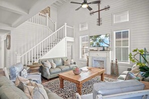 Relax in our cozy living room with soaring high ceilings and plush comfort all around.