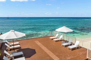 The beach deck is your front row seat to ocean views on Seven Mile Beach.  