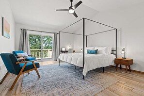 The master bedroom.  It has a king size bed with 100% cotton sheets and bedding for you to enjoy. There is a small seating area for you to sit and relax at. As well as a small desk space for you to use. 