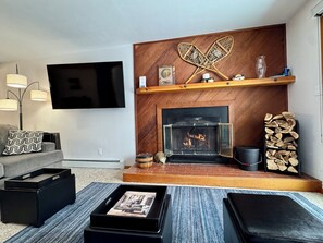 Cozy living room with wood burning fireplace.