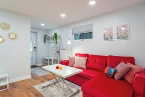 Living room/kitchen are modern, comfy, bright and cheery